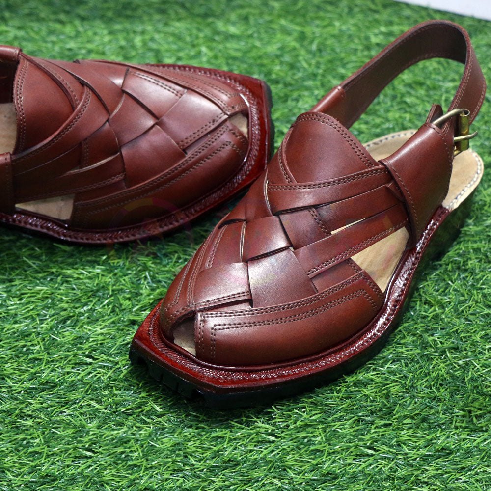 Brown woven sandals on a green grass-like surface